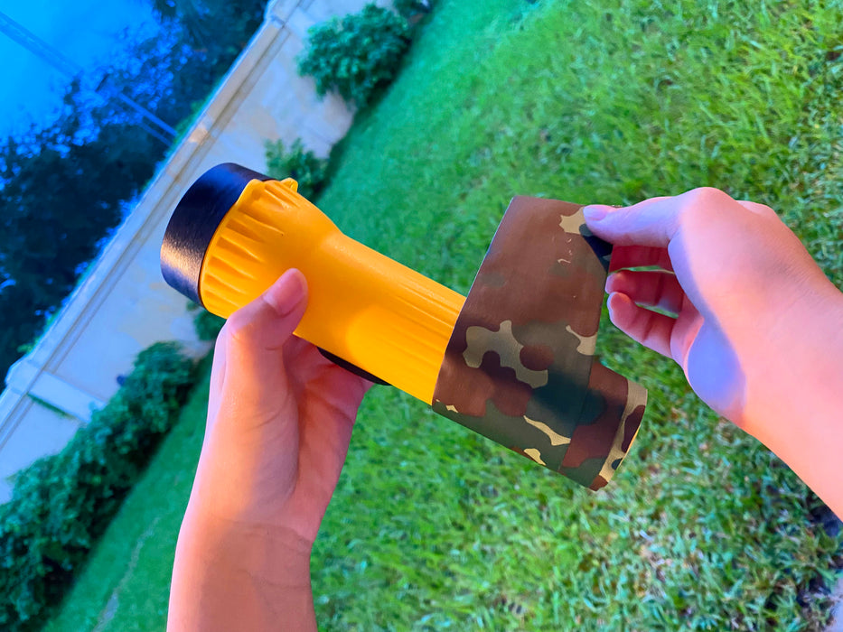camo duct tape wrapped on a yellow flashlight