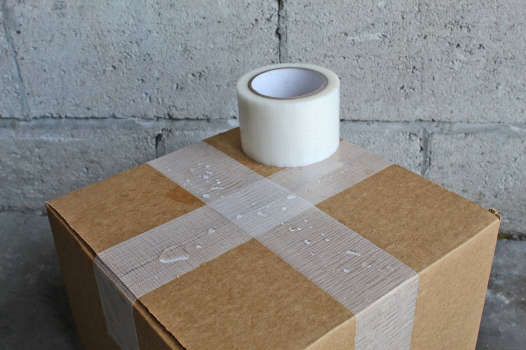clear gorilla duct tape used on a shipping box and picture shows waterproof property of the tape