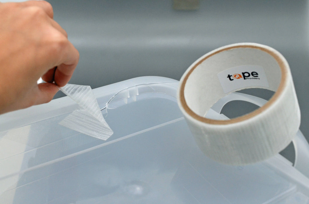 transparent duct tape being used to repair clear plastic bin