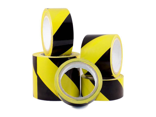 4 rolls of black and yellow safety tape of different widths stacked upon each other