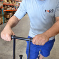 individual showing hand-held feature of floor tape dispenser tool