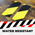 infographic of black and yellow hazard tape saying it is water resistant