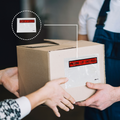 Envelope saying "Packing List Enclosed" taped to a shipping box