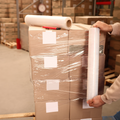 Individual wrapping shipping boxes with stretch wrap packaging plastic film