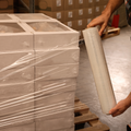 Individual wrapping shipping boxes on a pallet with stretch wrap packaging plastic film