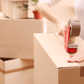 Carton Sealing Packaging Tape being applied on a shipping box with tape dispenser