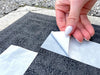Double Sided Polypropylene Tape being applied on carpet and backing being peeled off