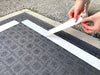Double Sided Polypropylene Tape being applied on carpet and backing being peeled off