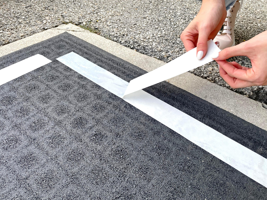 Double Sided Polypropylene Tape being applied on carpet and backing being peeled off