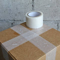 clear gorilla duct tape used on a shipping box and picture shows waterproof property of the tape