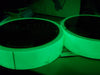 close up of two rolls of glow in the dark tape glowing in the dark / 1 inch wide