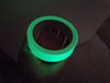 Close up of glow in the dark tape roll glowing - 1 inch