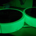 close up of two rolls of glow in the dark tape glowing in the dark / 1 inch wide