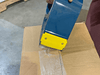 Close up of filament tape gun being used on a shipping box