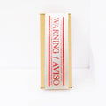 Warning / Aviso Carton Sealing Tape applied on a shipping box