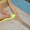 Close up of  Fiberglass Cloth Teflon Tape roll with liner pulled back