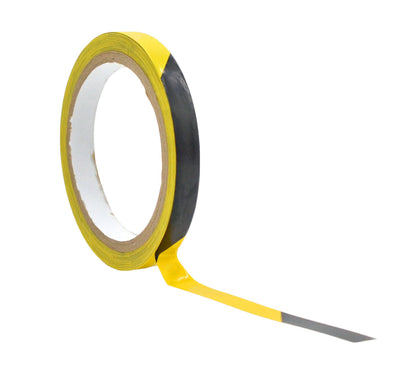 Roll of  black and yellow saftey hazard floor tape 