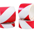 different width rolls of white and red safety hazard floor tape