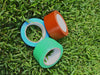 Three rolls each of different colors and sizes floor marking vinyl tape on grass