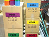 Stack of shipping boxes labeled by marker with different colors of floor marking tape