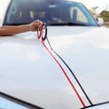 Hood of a car decorated with 1/4 inch black and red pinstripe tape